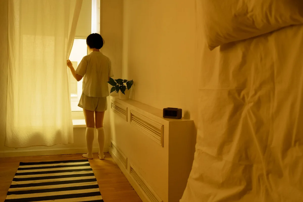 Personne isolée dans une chambre, respectant les mesures de confinement à domicile