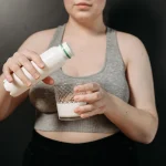 Gros plan sur le lait versé dans un verre pour vérifier son apparence et sa texture
