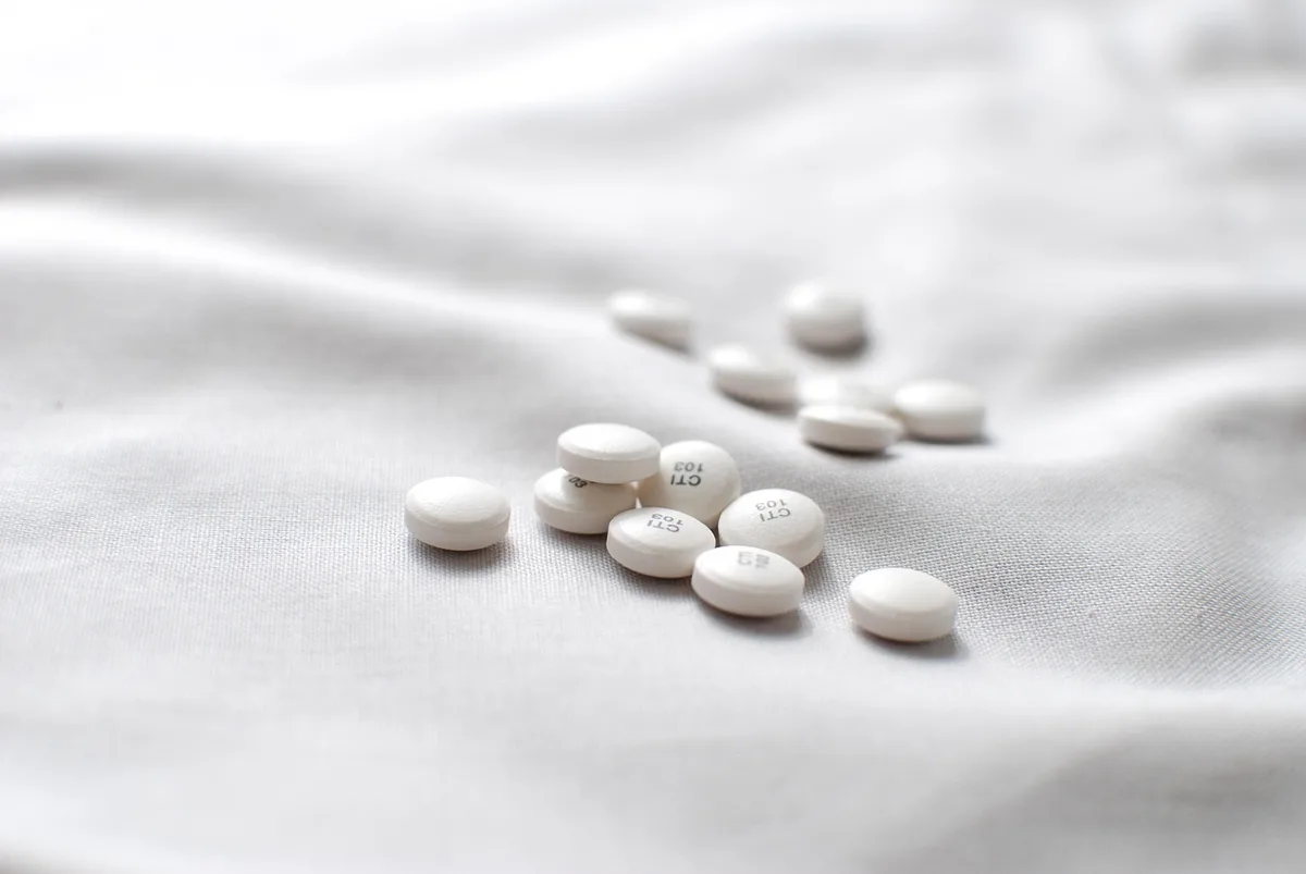 Boîte de compléments probiotique et capsules sur une table de cuisine